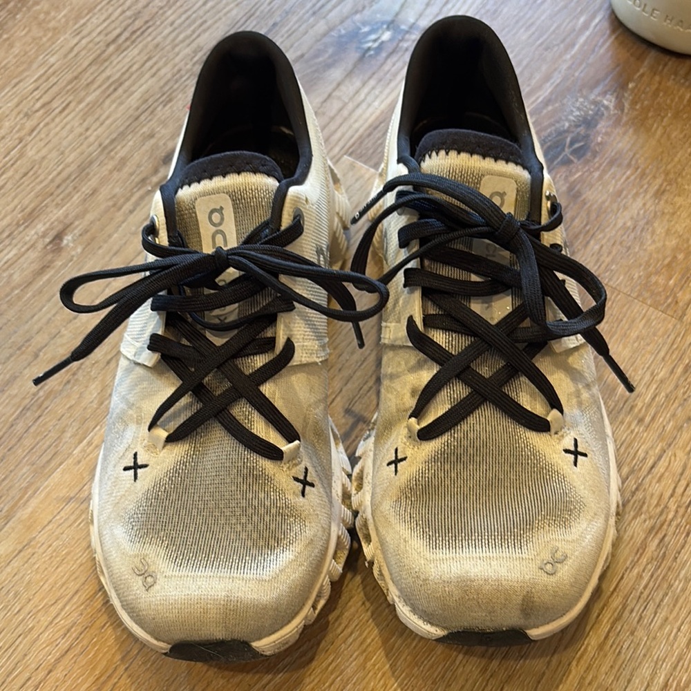 On Running Cream and Black Sneakers